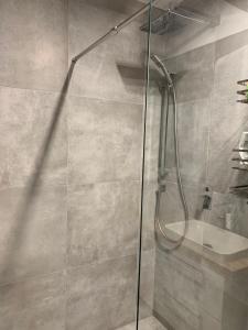 a shower with a glass door in a bathroom at Apartament Cieplice in Jelenia Góra