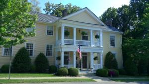 a white house with an american flag in front of it at Governor's Corner Bed & Breakfast in Russellville