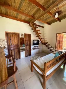 une chambre avec un lit et un plafond en bois dans l'établissement Vila Uryah, à Caraíva 159 autres photos
