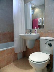 a bathroom with a white toilet and a sink at Apartments Center in Sandanski +21 photos