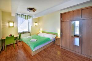 A bed or beds in a room at Penzión Víchrica