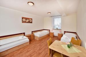 A bed or beds in a room at Penzión Víchrica