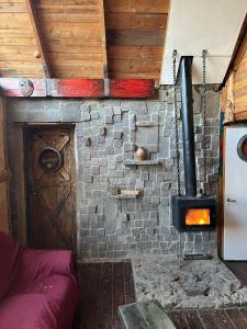 a brick fireplace with a stove in a room at Ma-hai in Ushuaia