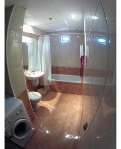 a bathroom with a tub and a toilet and a sink at Apartments Center in Sandanski