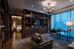 a living room with a couch and a tv and a bedroom at The Westin Galleria Houston in Houston