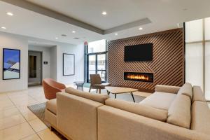 a living room with a couch and a fireplace at Holiday Inn Mobile Airport by IHG in Mobile