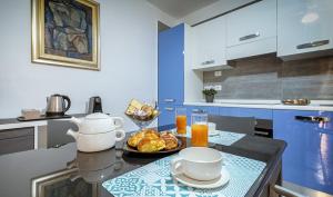a kitchen with a table with food and drinks on it at casa Klaire Pozzuoli in Pozzuoli