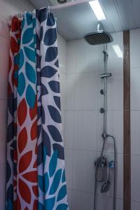 a shower with a shower curtain in a bathroom at Studio K2 in Skopje