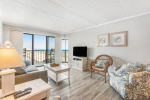 a living room with a couch and a television at Summer Beach 506 in Ocean City