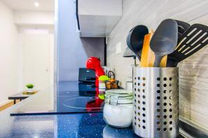 a container of utensils on a counter in a kitchen at Acogedor Loft Centro Murcia in Murcia