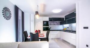 a kitchen and dining room with a table and chairs at Apartman PAOLA in Vrh
