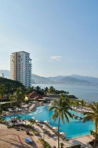 a view of a resort with palm trees and the ocean at Marriott Puerto Vallarta Resort & Spa in Puerto Vallarta