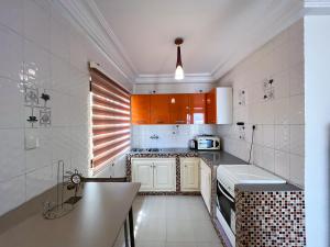 a kitchen with white cabinets and a counter top at RÉSIDENCES MOROLA - SENA in Dakar