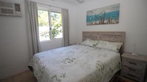 a bedroom with a bed and a window at Unit 5 Beachcomber, Arcadia in Arcadia +9 photos
