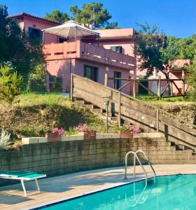 a house with a swimming pool in front of a house at Sera & Mattino Appartamenti by SolturElba in Capoliveri