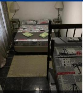 two twin beds in a room with at Augusta Jardins Home in Sao Paulo