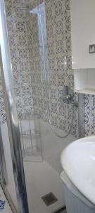 a bathroom with a shower with a toilet and a sink at CASA GIULIA in Levanto