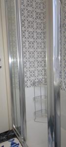 a shower with a glass door in a bathroom at CASA GIULIA in Levanto