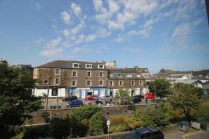 a city with cars parked in a parking lot at Six Stevenson House, Oban in Oban