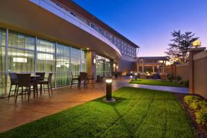 a patio with a table and chairs in the grass at Courtyard Omaha La Vista in La Vista