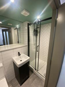 a bathroom with a sink and a shower at Urban Pod Hotel Liverpool in Liverpool