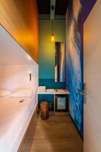 a bedroom with a bed and a desk with a sink at Polynesian Cabins by Kon Tiki in Papeete