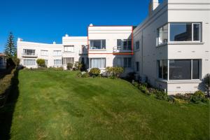 a large grassy yard in front of a building at Art Deco Beauty on The Bay Hill in Timaru