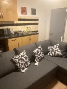 a couch in a kitchen with pillows on it at 3 Bed Sea View Apartment @ 10B George Street in Ryde