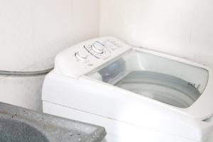 a white washing machine in a small bathroom at Rancho Boa Vista in Barreirinhas
