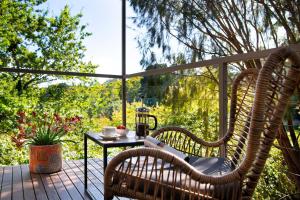 a patio with two chairs and a table on a deck at Daylesford Spa Villa 5 in Daylesford