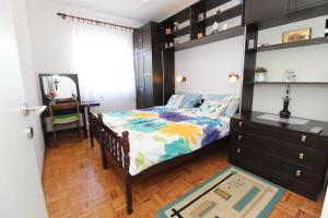 a bedroom with a bed and a dresser and a mirror at Apartments for families with children Novalja, Pag - 6490 in Novalja