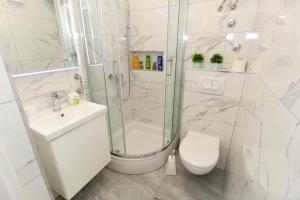 a bathroom with a shower and a toilet and a sink at Apartments for families with children Novalja, Pag - 6490 in Novalja +40 photos