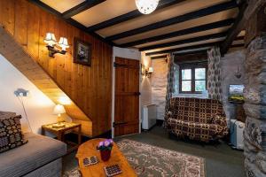 a living room with a couch and a table at Glan Lledr in Betws-y-coed