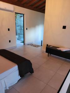 a bedroom with a bed and a tiled floor at BrotasLoft in Brotas