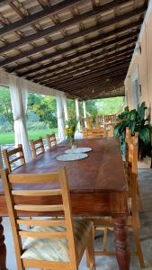 - une table et des chaises en bois dans la salle à manger dans l'établissement Sítio Maranata Vale das Montanhas, à Monte Alegre do Sul