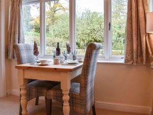 a table and chairs in front of a window at Swallows - Uk41742 in Mayfield