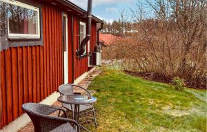 a patio with two chairs and a table next to a building at Lovely Home In Kosta With Wifi in Kosta