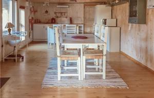 a white dining room table and chairs in a kitchen at Lovely Home In Kosta With Wifi in Kosta