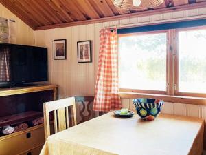 a dining room with a table with a bowl on it at Holiday home LIDKÖPING IX in Tallbacken