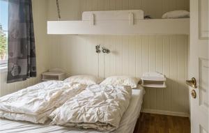 an unmade bed in a bedroom with a shelf at Nice Apartment In Trysil With House A Panoramic View in Trysil