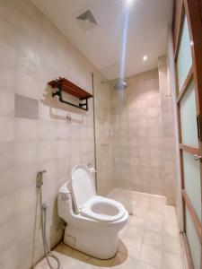 a bathroom with a toilet and a shower at Augustina Home in Malang