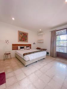 a bedroom with a large bed and a large window at Augustina Home in Malang