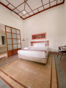 a bedroom with a large bed and a table at Augustina Home in Malang