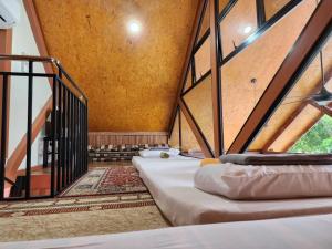 a room with three beds in a room with an attic at Homestay Umbai Kelana in Merlimau