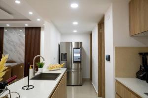 a kitchen with a stainless steel refrigerator and a sink at Livera in Santiago de los Caballeros