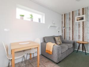 a living room with a couch and a table at Endless Summer in Newquay