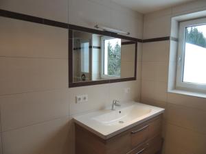 a bathroom with a sink and a mirror at Z`Aglers Ferienwohnungen in Oberau +14 photos