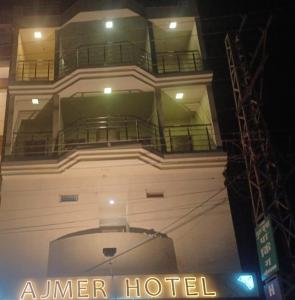 a building with a hotel sign in front of it at Hotel Ajmer in Ajmer