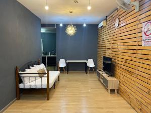 a room with a bed and a table with chairs at Stylishly Spacious in Tanjung Bungah