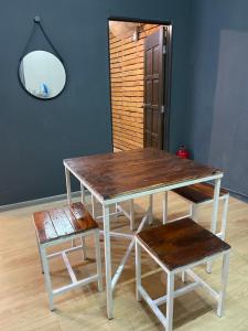 a wooden table with a bench and a mirror at Stylishly Spacious in Tanjung Bungah